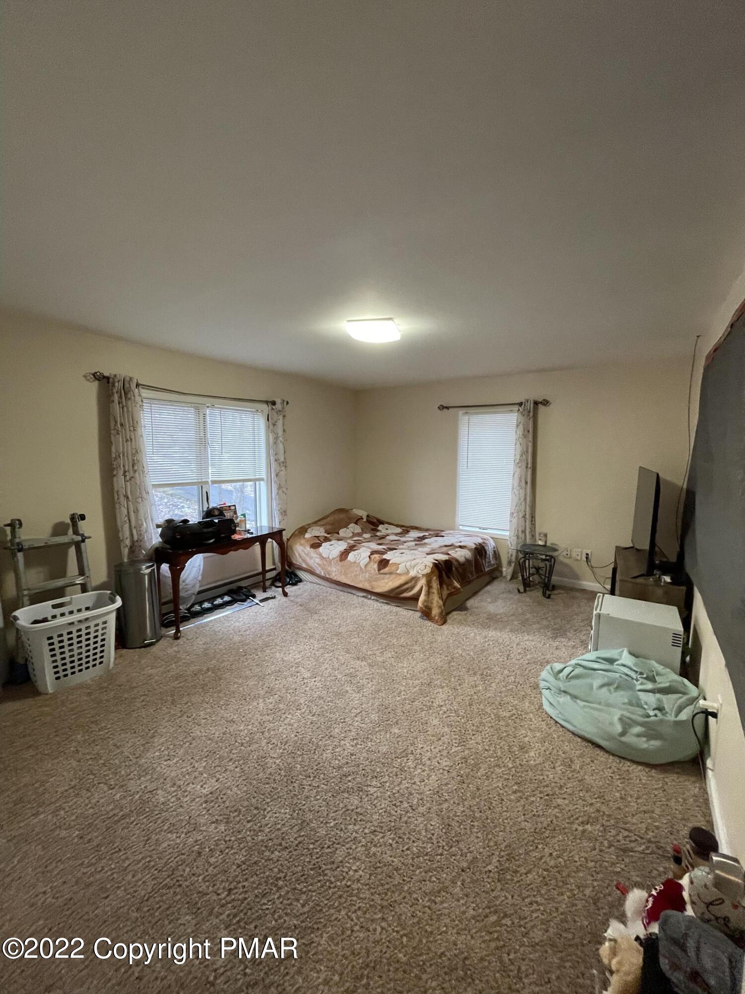 5665 Decker Road Bushkill, PA 18324 - Photo 21 of 32 a living room with furniture and a flat screen tv