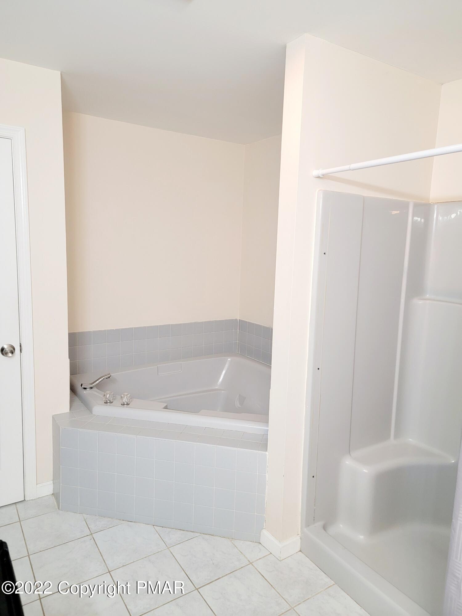 5665 Decker Road Bushkill, PA 18324 - Photo 24 of 32 a bathroom with a bathtub and a shower