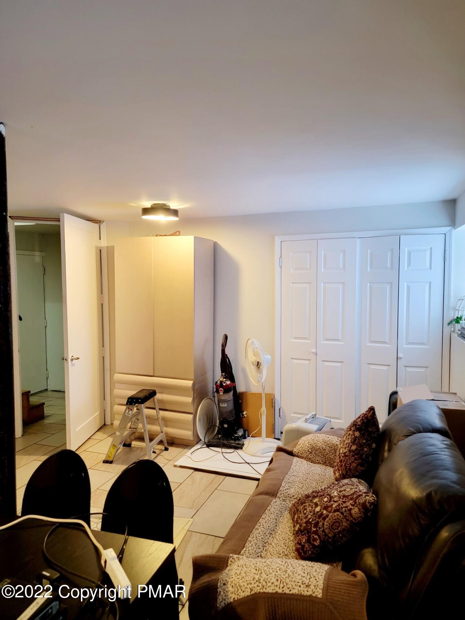 5665 Decker Road Bushkill, PA 18324 - Photo 28 of 32 a living room with furniture and a large window