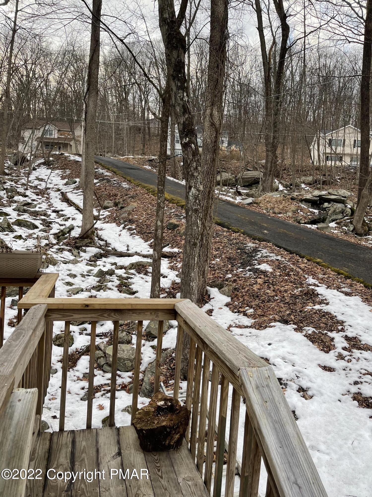 5665 Decker Road Bushkill, PA 18324 - Photo 3 of 32 a view of a street with wooden bench next to a yard