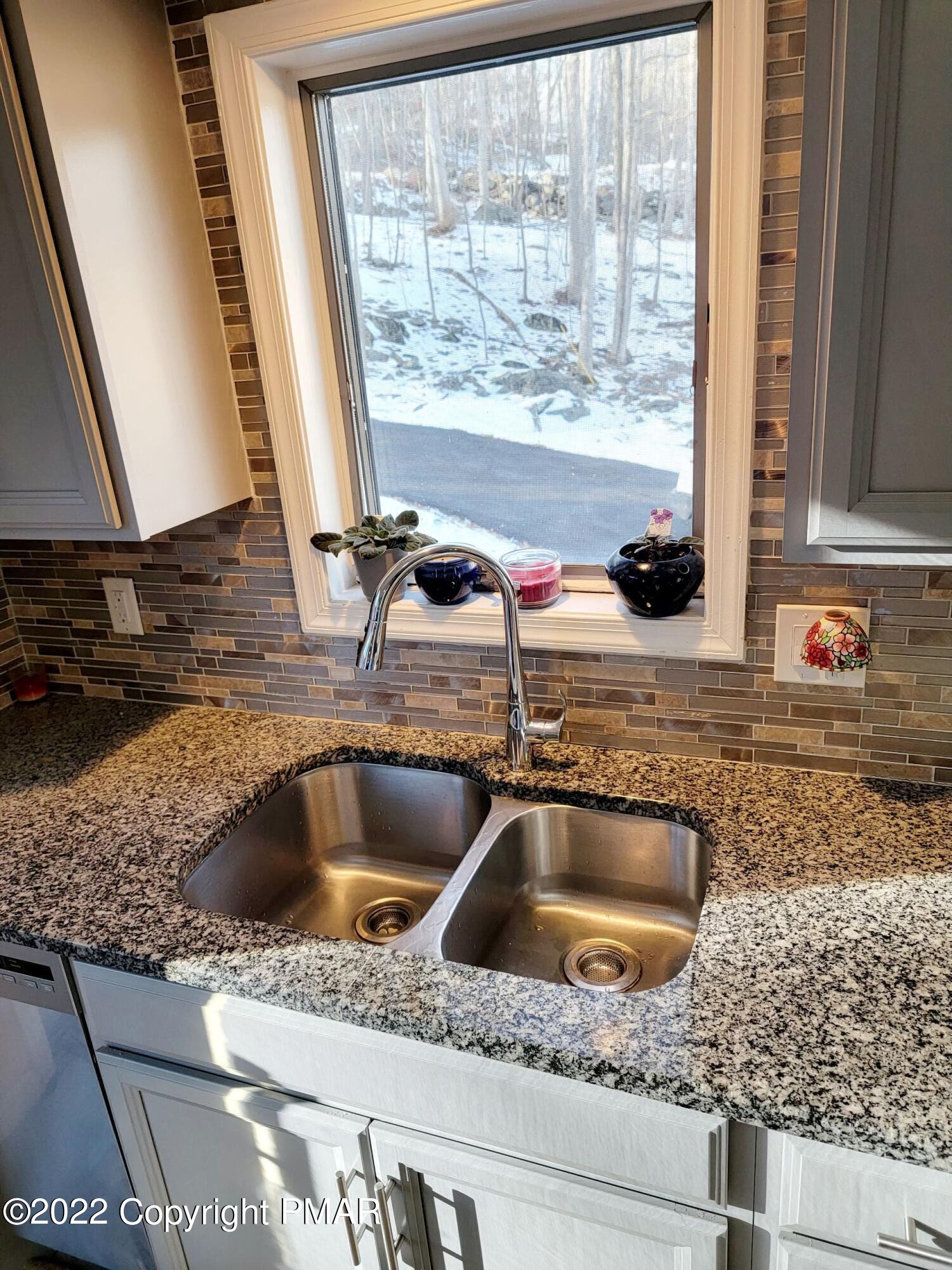 5665 Decker Road Bushkill, PA 18324 - Photo 8 of 32 a kitchen sink with a granite countertop a sink and granite next to a window
