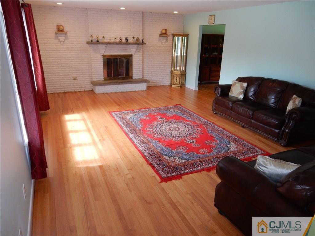 428 Morristown Road Old Bridge, NJ 07747 - Photo 2 of 25 a living room with furniture and a fireplace