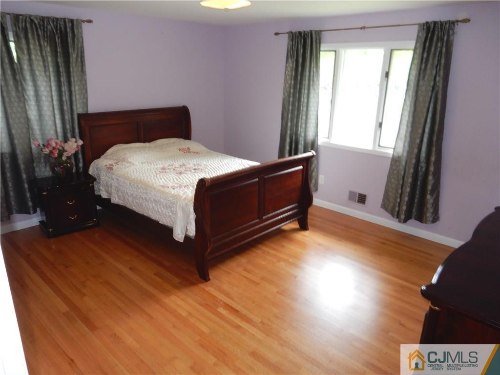 428 Morristown Road Old Bridge, NJ 07747 - Photo 13 of 25 a bedroom with a bed and window