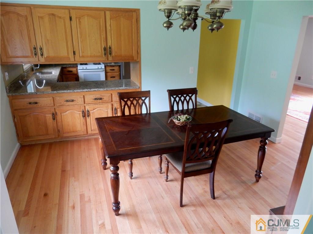 428 Morristown Road Old Bridge, NJ 07747 - Photo 6 of 25 a view of a dining room with furniture and wooden floor