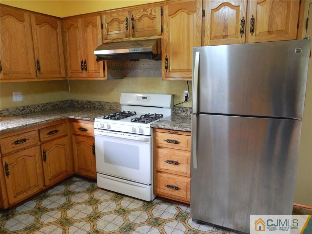428 Morristown Road Old Bridge, NJ 07747 - Photo 8 of 25 a kitchen with appliances cabinets and furniture