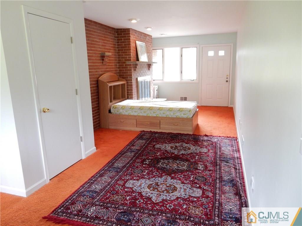 428 Morristown Road Old Bridge, NJ 07747 - Photo 10 of 25 a bath room with a rug and a fireplace