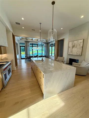 a kitchen with a table chairs and refrigerator