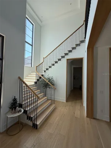 a large bedroom with a bed and a flat screen tv