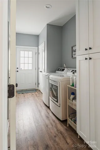 a utility room with closet dryer and washer