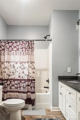 a bathroom with a toilet and a shower