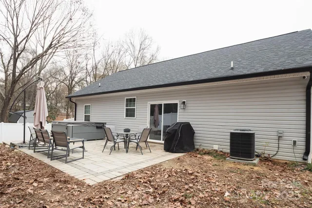 a view of a patio with dining table and chairs with wooden floor and fence