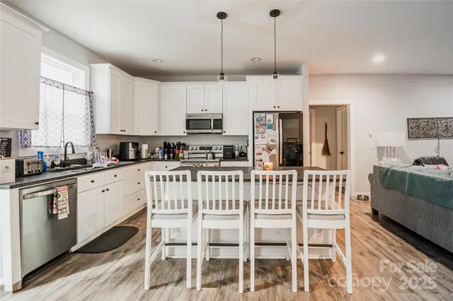 a kitchen with stainless steel appliances kitchen island granite countertop a sink and cabinets