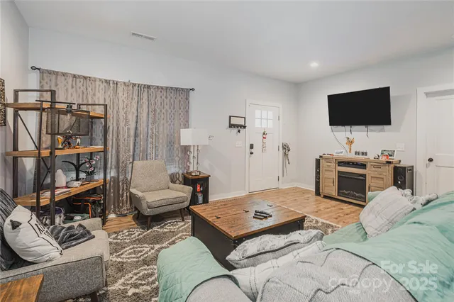 a bedroom with furniture and a flat screen tv