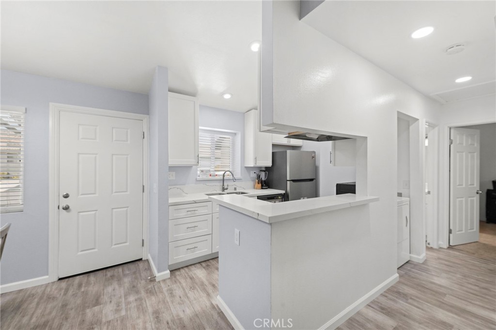 9505 Arlington Avenue, Unit 54 Riverside, CA 92503 - Photo 11 of 29 a kitchen with white cabinets and white appliances