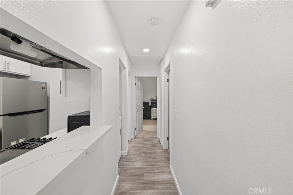 9505 Arlington Avenue, Unit 54 Riverside, CA 92503 - Photo 17 of 29 a hallway with a white cabinets