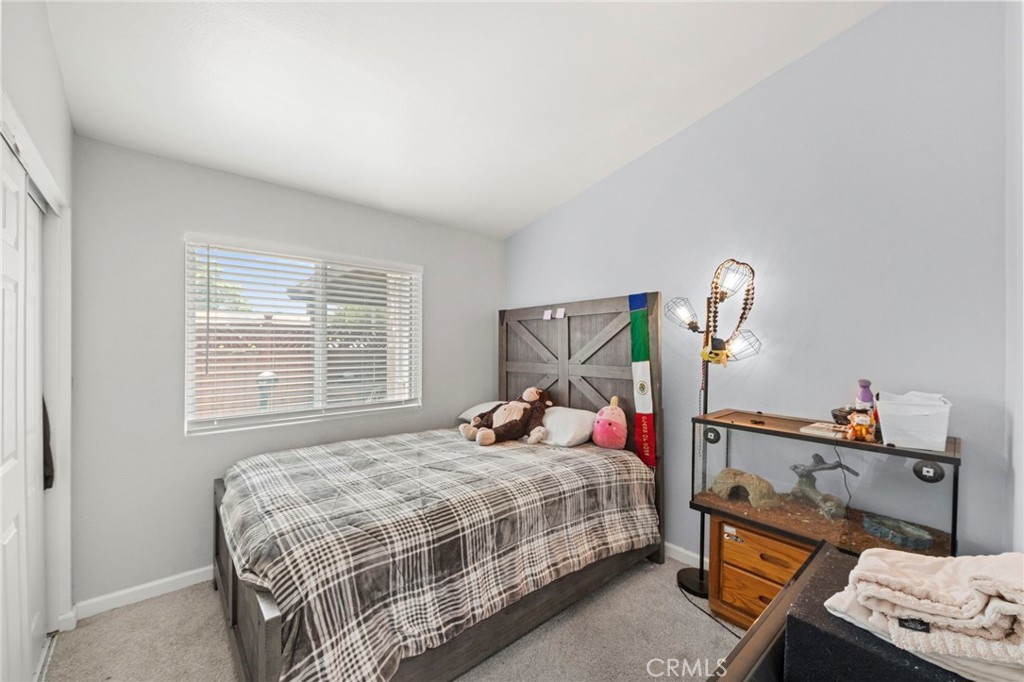 9505 Arlington Avenue, Unit 54 Riverside, CA 92503 - Photo 18 of 29 a bedroom with a bed and a window