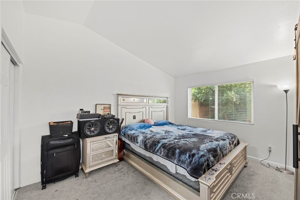 9505 Arlington Avenue, Unit 54 Riverside, CA 92503 - Photo 20 of 29 a bedroom with a bed and two windows