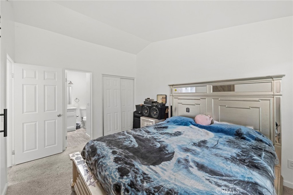 9505 Arlington Avenue, Unit 54 Riverside, CA 92503 - Photo 21 of 29 a bedroom with a bed and closet