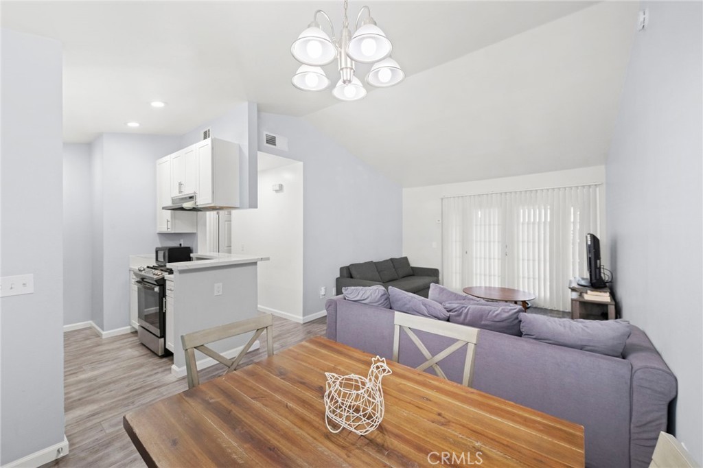 9505 Arlington Avenue, Unit 54 Riverside, CA 92503 - Photo 8 of 29 a living room with furniture and a chandelier