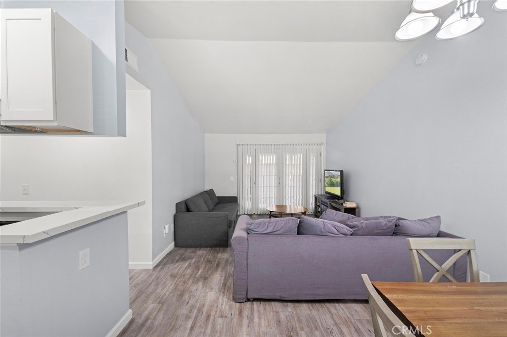 9505 Arlington Avenue, Unit 54 Riverside, CA 92503 - Photo 9 of 29 a living room with furniture and a wooden floor