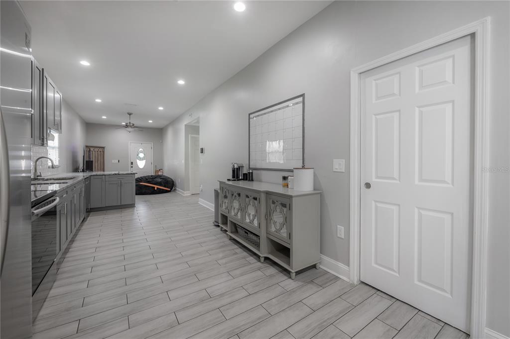 2341 West Chestnut Street Tampa, FL 33607 - Photo 15 of 42 a kitchen with stainless steel appliances kitchen island granite countertop a stove a sink and a refrigerator