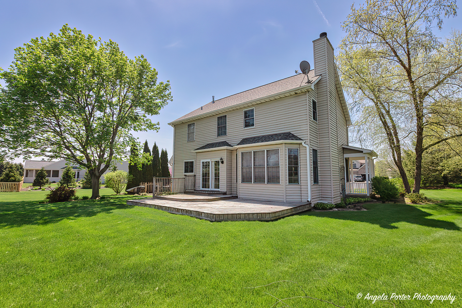 10916 East Riviera Drive Spring Grove, IL 60081 - Photo 34 of 43 a front view of a house with a yard table and chairs