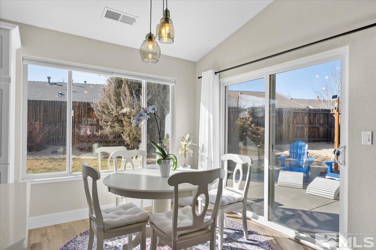 1870 D'Arques Court Reno, NV 89521 - Photo 12 of 33 a dining room with furniture a chandelier and glass door