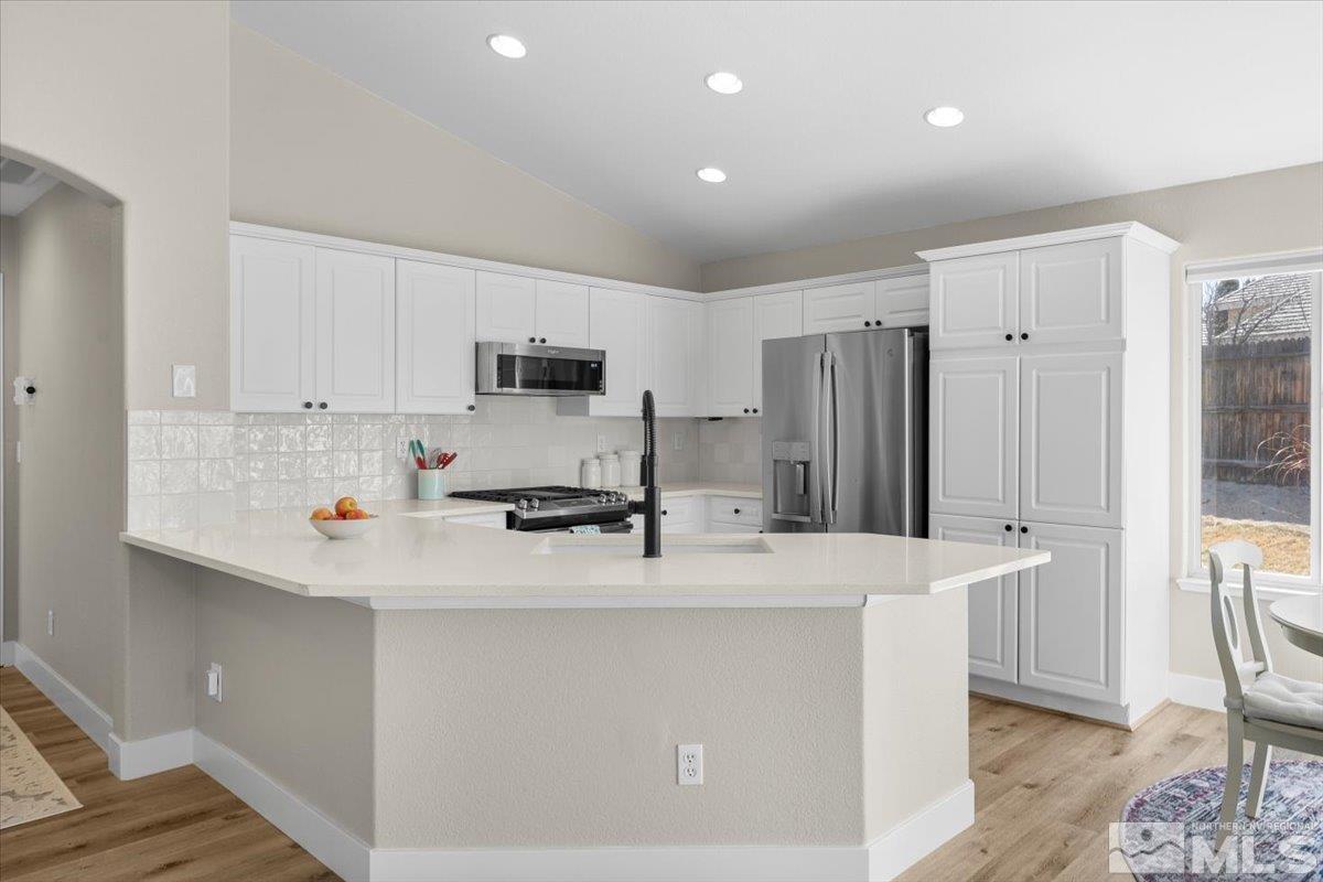 1870 D'Arques Court Reno, NV 89521 - Photo 13 of 33 a kitchen with stainless steel appliances a refrigerator sink and cabinets