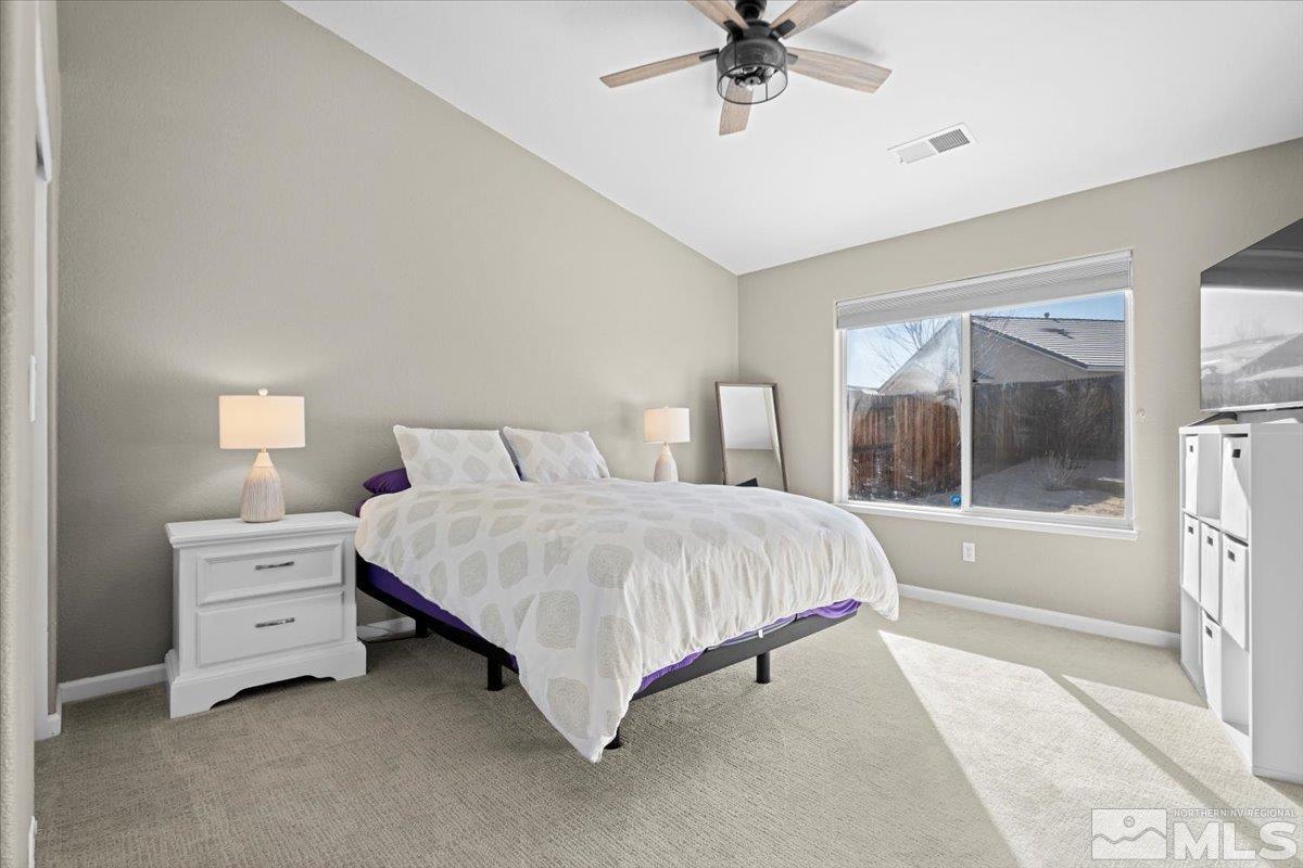 1870 D'Arques Court Reno, NV 89521 - Photo 17 of 33 a spacious bedroom with a bed and a chandelier