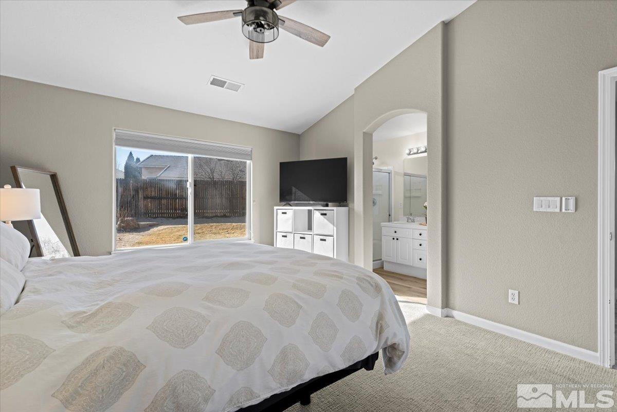 1870 D'Arques Court Reno, NV 89521 - Photo 19 of 33 a spacious bedroom with a large bed and a flat tv screen on dresser