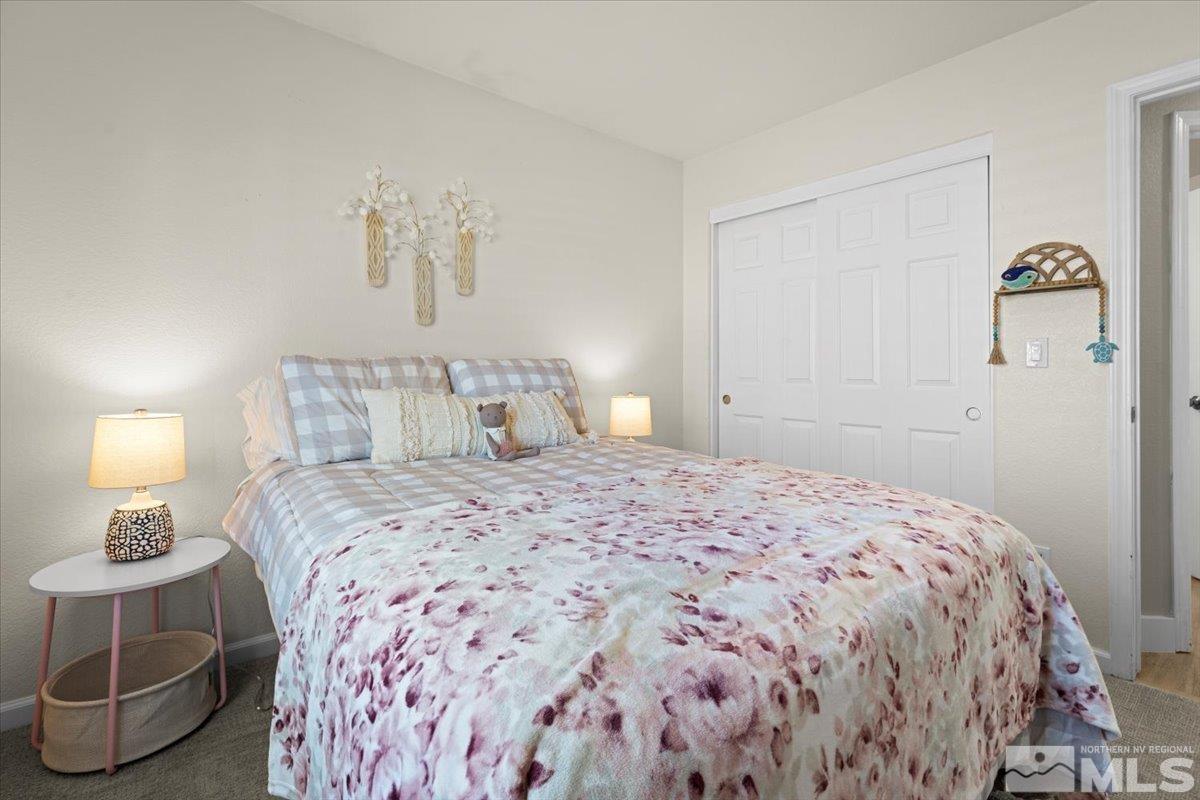 1870 D'Arques Court Reno, NV 89521 - Photo 22 of 33 a bedroom with a bed and a lamp
