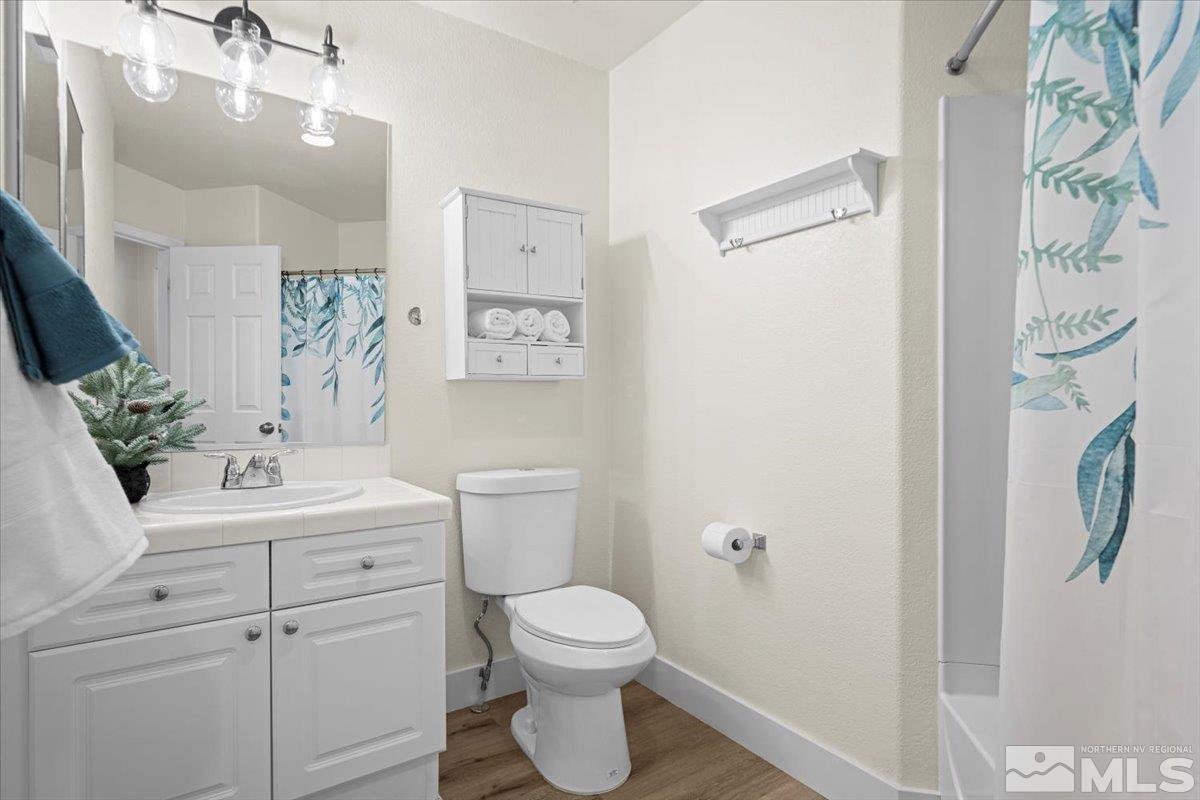 1870 D'Arques Court Reno, NV 89521 - Photo 23 of 33 a bathroom with a toilet sink vanity granite and shower