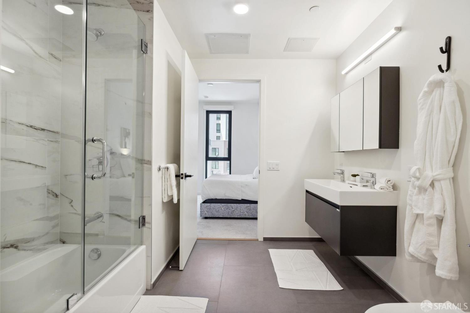 988 Harrison Street, Unit CK3 San Francisco, CA 94107 - Photo 12 of 15 a bathroom with a tub sink and mirror