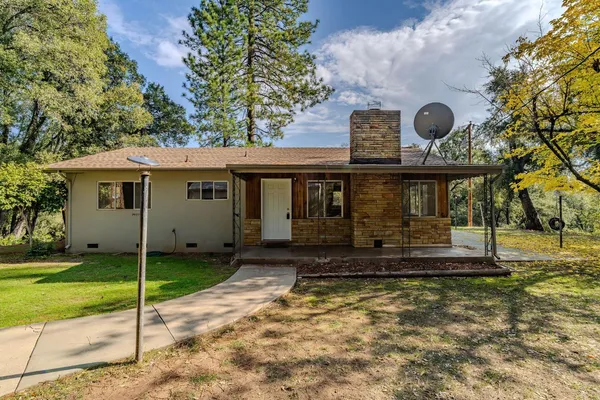 a front view of a house with a yard covered in snow