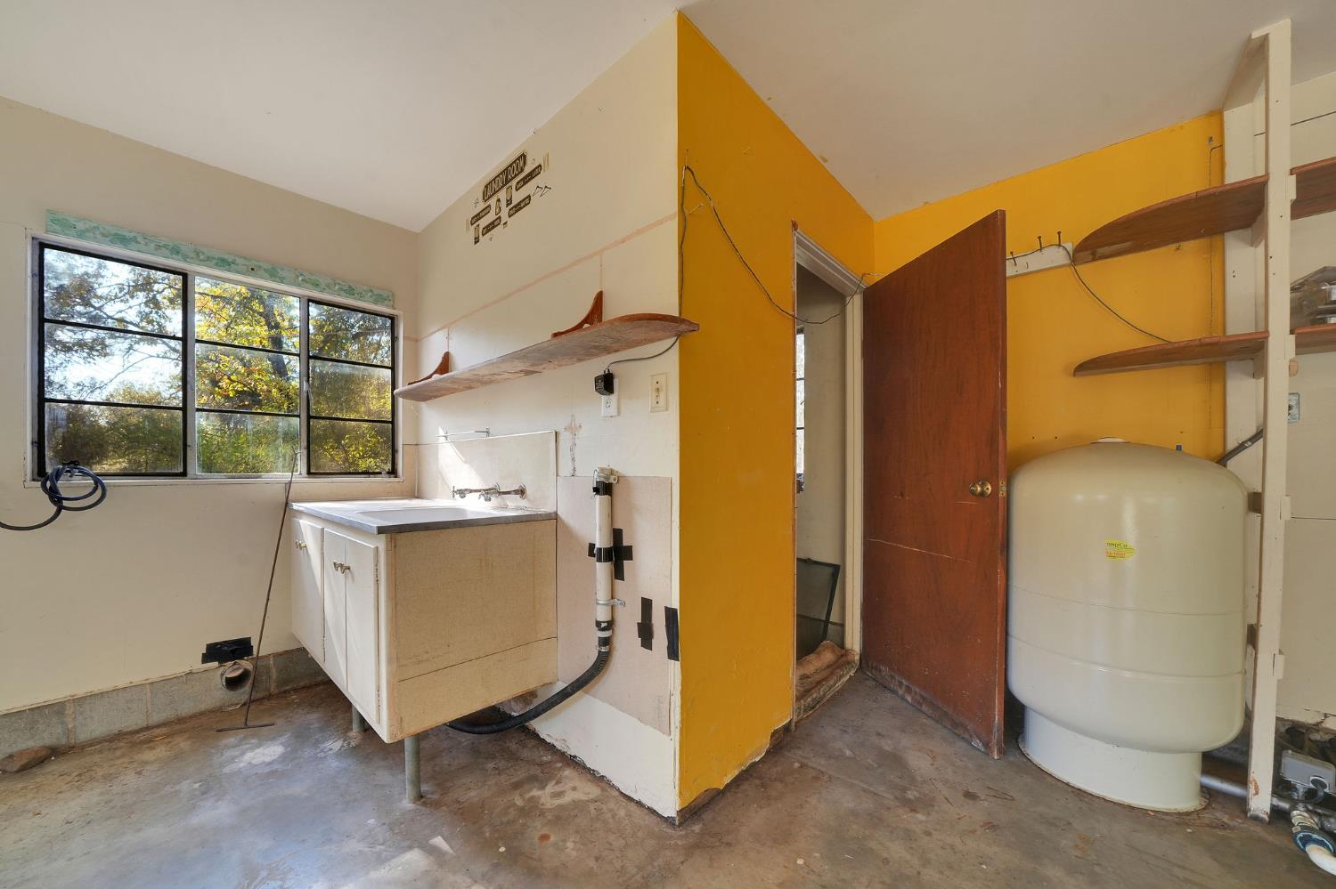 13309 Taves Road Jackson, CA 95642 - Photo 35 of 62 a utility room with cabinets dryer and washer
