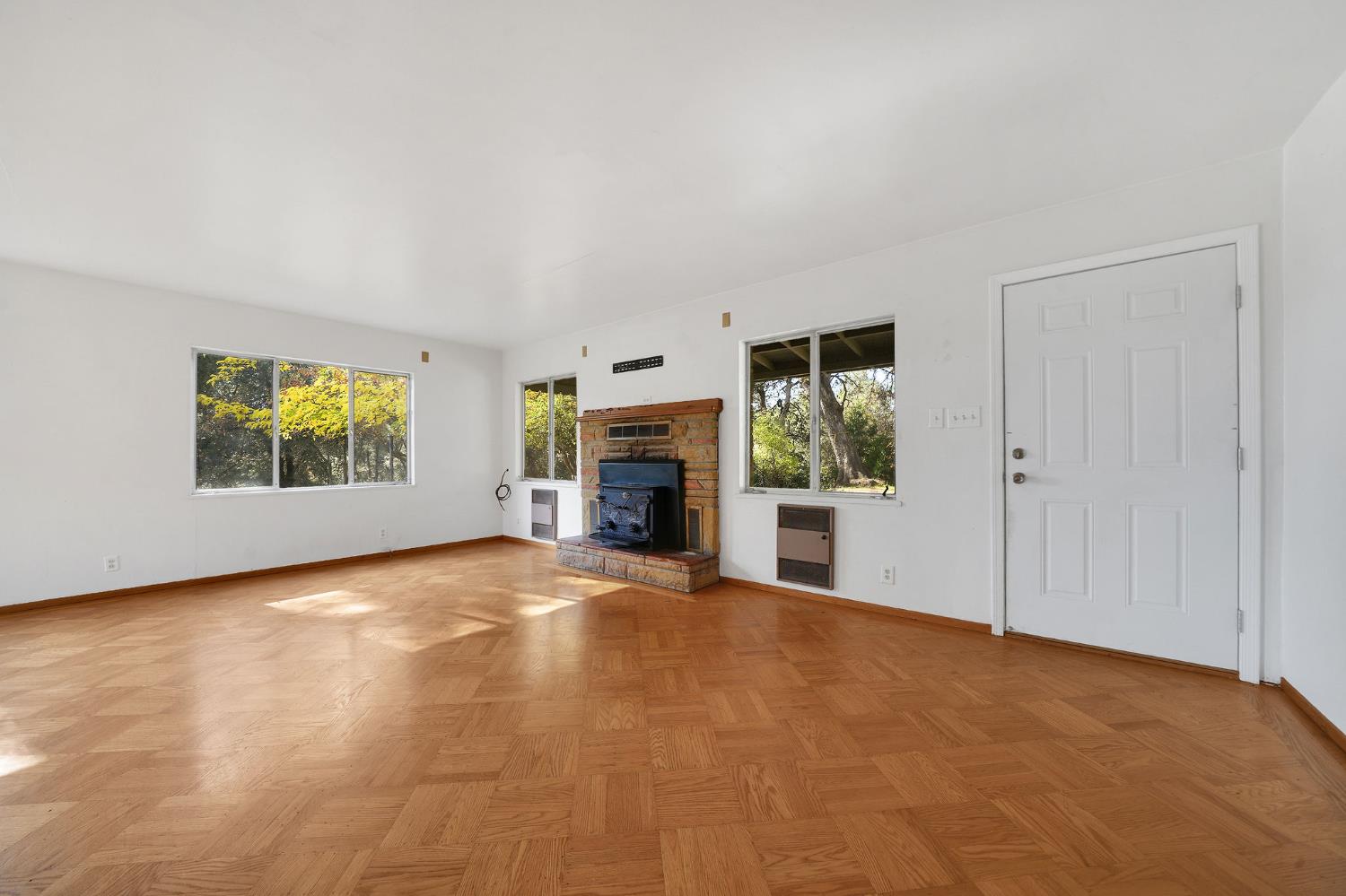 13309 Taves Road Jackson, CA 95642 - Photo 38 of 62 an empty room with windows fireplace and small yard