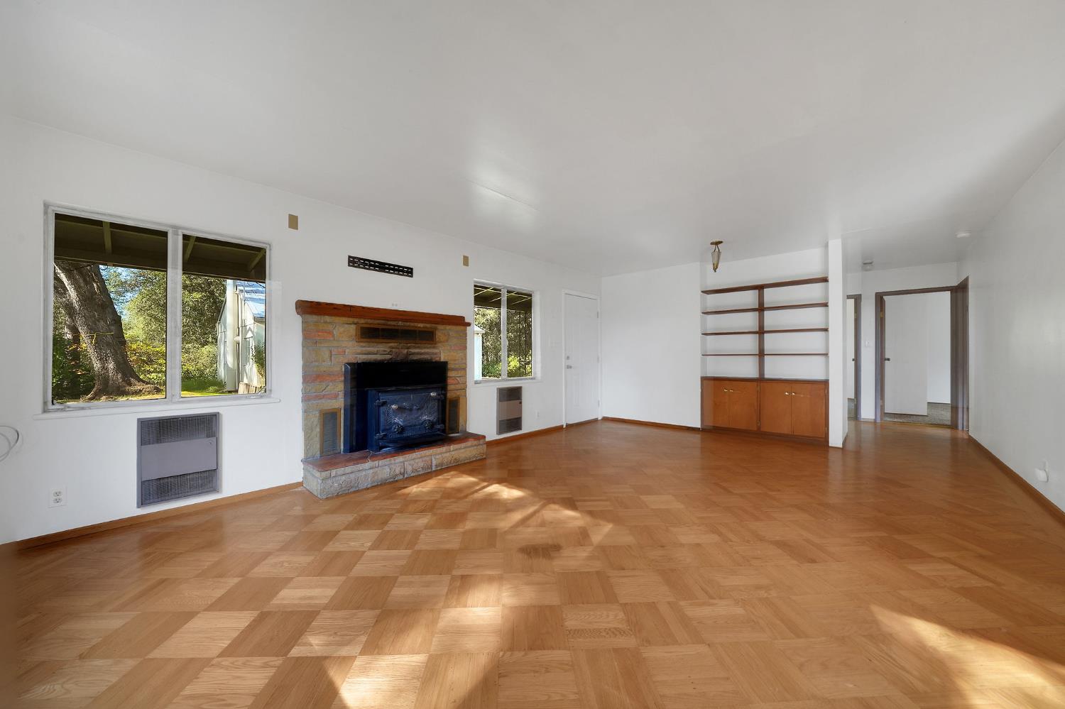 13309 Taves Road Jackson, CA 95642 - Photo 40 of 62 a view of an empty room with a fireplace and a window