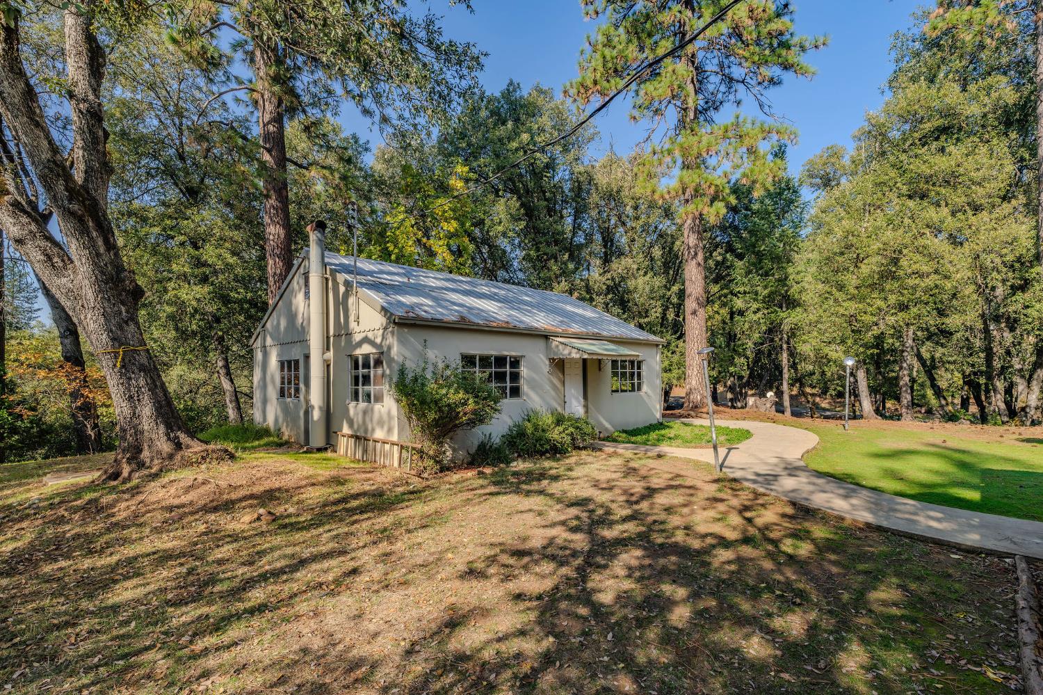 13309 Taves Road Jackson, CA 95642 - Photo 9 of 62 a front view of a house with a yard and trees