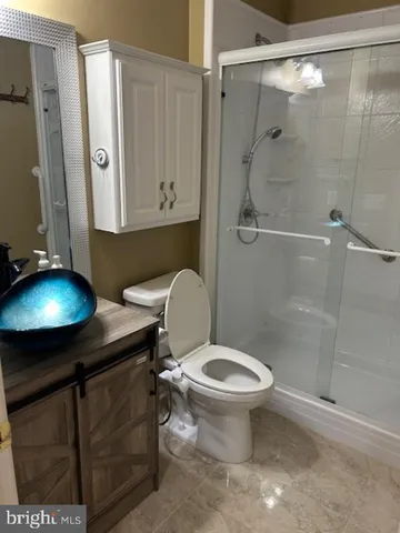 a bathroom with a toilet and a shower