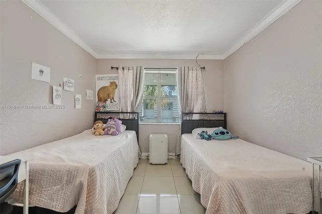 a bedroom with two beds and a large window