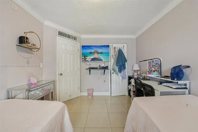 a bedroom with a bed and a view of living room