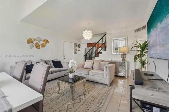 a living room with furniture and a potted plant