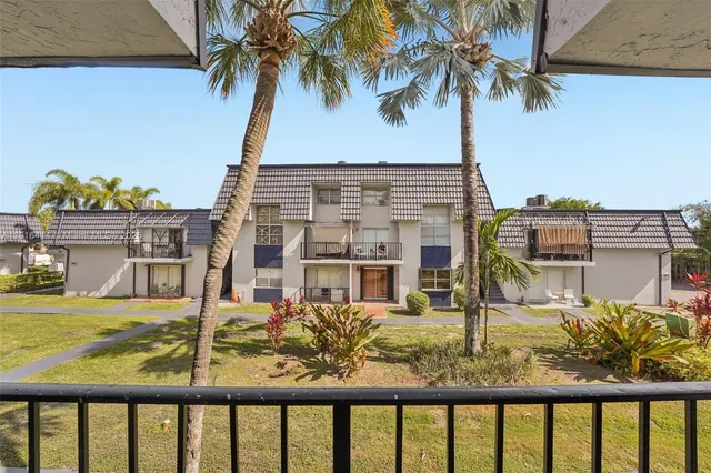 a view of a balcony with a ocean from a ceiling fan