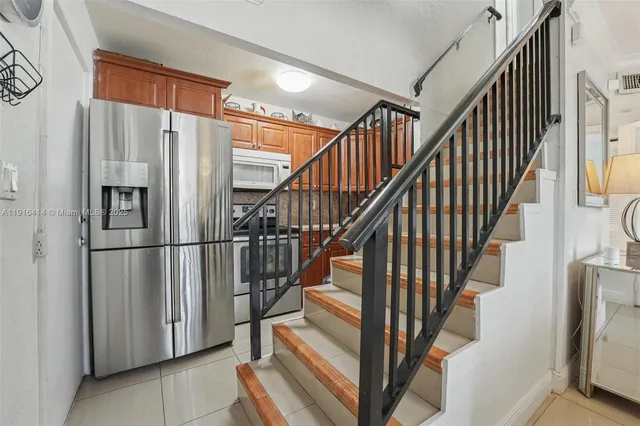 a view of staircase with lots of white walls and a window