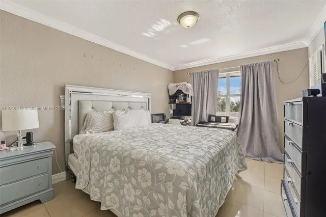 a bedroom with a large bed and a dresser