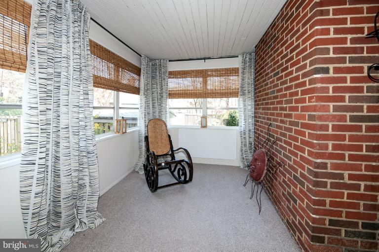 a view of a livingroom with workspace and a window