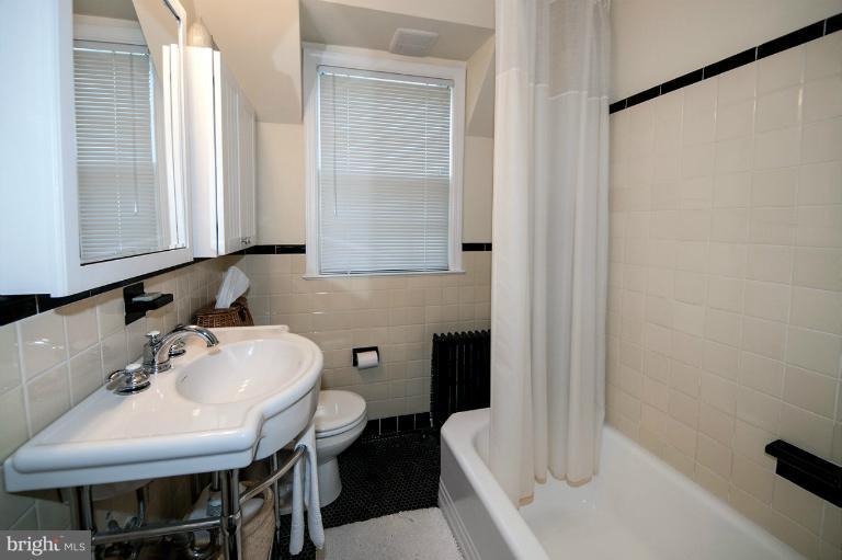 8813 Bradford Road Silver Spring, MD 20901 - Photo 2 of 23 a bathroom with a sink a toilet and a mirror
