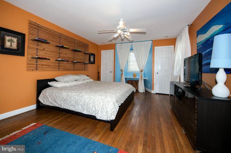 8813 Bradford Road Silver Spring, MD 20901 - Photo 15 of 23 a bedroom with a large bed and a chandelier