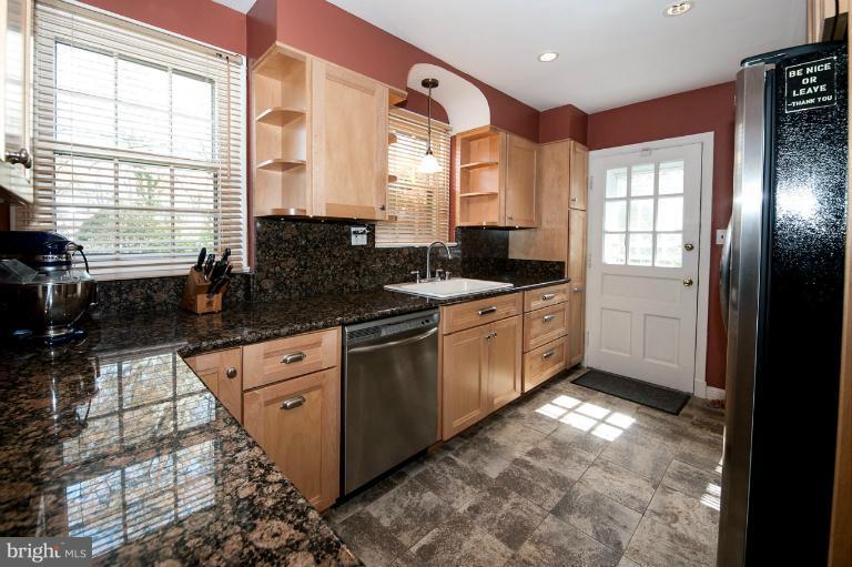 8813 Bradford Road Silver Spring, MD 20901 - Photo 7 of 23 a kitchen with granite countertop a stove a sink and a refrigerator