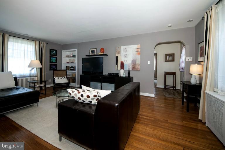 8813 Bradford Road Silver Spring, MD 20901 - Photo 10 of 23 a living room with furniture wooden floor and a fireplace